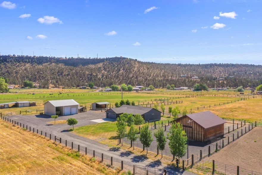 Exceptional horse property on 9.8 acres with 8 acres of irrigation.  This home has lots of updates including new heat pump, kitchen cabinets & quartz counter tops, vinyl laminate flooring and trim, lighting, blinds, vaulted ceiling & an open split floor plan & a large fenced yard.  Outside you will find a host of equestrian amenities including a barn & arena, stud barn with two runs, a chicken barn, multiple cross-fencing options.  The flood irrigation is well set up for ease of watering & multiple frost frees throughout the property.  The shop has a full concrete floor in the 2 bays with power, 3rd bay is gravel for RV parking or hay storage. This remarkable estate comprises two tax lots, each equipped with its own well and power supply, allowing for potential subdivision if desired.  Property is near the Crooked River Wetlands Complex.  Irrigation is $72.00 a year so very inexpensive to irrigate.