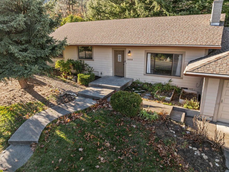 Great location above the boulevard in the desirable Mountain Ranch neighborhood, offering peaceful privacy and views of the surrounding mountains through expansive, light-filled windows. The home features a formal living room with a fireplace, an updated kitchen, a family room with vaulted ceilings, and an oversized garage. Set on a large, landscaped lot with Talent Irrigation Water rights and a dedicated point of connection, it's ready for you to expand your dream landscape. This pedestrian-friendly neighborhood offers a private park and is just minutes from the Oredson-Todd Woods trail system and Mountain Ranch's greenways.