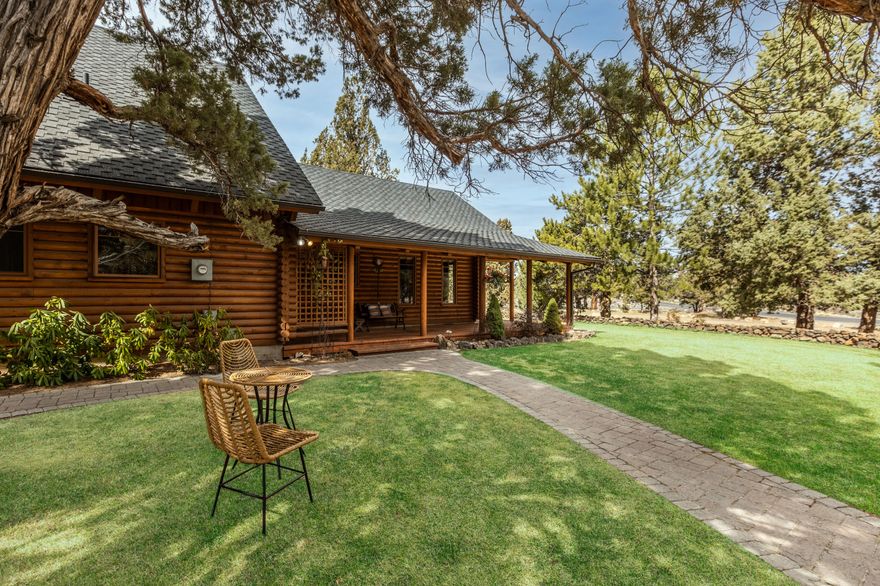 Welcome home! This stunning and well maintained log home is nestled in the treasured neighborhood of Boonesborough. Built on 2.59 acres, the natural beauty of Central Oregon surrounds you. Inside the home, the main floor offers an open floor plan, vaulted ceilings, primary bedroom and guest bedroom. As you walk up the spiral staircase, you will find a spacious bonus room, bedroom and bath. From the exterior wrap-around porch and upper deck, take in the sights and sounds of the expansive water feature that includes a walking bridge and too many plants to mention. On the property you'll find a luscious Peony Garden. Off the circular driveway, the ample 3-car garage offers room for all your cars, toys and also includes a fixed air compressor and wood burning stove. Next door to the garage you will find the fully equipped RV storage garage.