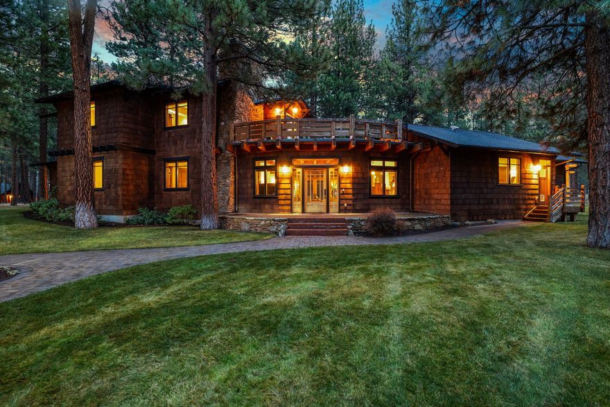 A unique masterpiece inspired by the Pratt House on the Casa Barranca estate in Ojai, CA. This home showcases meticulous craftsmanship w/ post & beam construction, maple flooring, a stone wood-burning fireplace, & expansive windows framing views of the Forest. A true chef's kitchen boasts professional-grade appliances & an impressive island w/ a prep sink, complemented by a spacious dining area for entertaining. The main level includes an ensuite & an additional bedroom & bath. Upstairs, a private master suite awaits, offering forested views & a private roof deck. The beautiful primary bath features travertine floors, a generous walk-in shower, tile tub, & a spacious walk-in closet. Enjoy summer evenings in a private Central Oregon setting on half an acre surrounded by ponderosa pines. Two detached 2-car garages provide ample storage for cars & toys. This one-of-a-kind home is conveniently located near the brewery, movie theater, & other amenities, including 5 Pine Lodge.