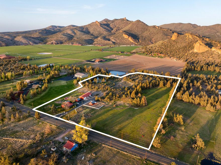 This amazing opportunity is waiting for you! Come explore this incredible piece of history and make it yours. With 5 acres of irrigated pasture and farmland, and an additional 10 acres of wooded area complete with a private lake and boat dock, the possibilities are unlimited. As you enter the private, gated paradise, you will see the charming farmhouse constructed in an era gone by on the north side, along with a fruit cellar, huge garden, chicken coup, bunkhouse, orchard, and lush green pastures. In addition, the newer shop is huge with 3 RV bays, a regular 2-car bay, a walk-in lube bay, and tons of room, not to mention the heated flooring. This is every mechanic's dream shop. To the south, you will see a horse barn, 4 acres of lush, irrigated pasture, and dynamic views of the Cascade Mountains. Eastward, a road leads to a fantastic building site, should you choose to replace the existing home, along with a private lake fed by an unrestricted 4'' irrigation feed from the COID canal.