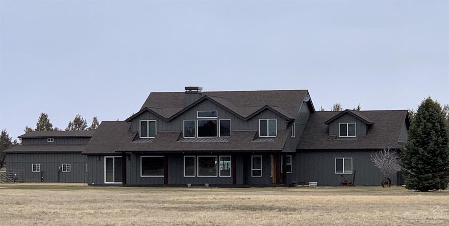 Treasure this special view of the Cascade Mountains overlooking irrigated pasture. Four bedrooms, 4 baths, 3850+ sq.ft. custom home with multi-use barn/shop outbuilding. A paved circular drive leads to the quality constructed home in like-new condition. Enjoy unobstructed mountain views from the many windows providing natural light in abundance throughout the home. Spacious kitchen with large cooking island and ample counters and cabinetry feel a part of the great room with a soaring ceiling and gas fireplace set in dramatic floor to ceiling river rock display. Plenty of flexibility in living space. In addition to primary bedrooms, enjoy an office/den and bonus rooms. Property is fenced and cross-fenced and served with 5 acres of Three Sisters Irrigation District pressurized water delivered to the property. Nearby access to BLM property for riding and outdoor recreation.