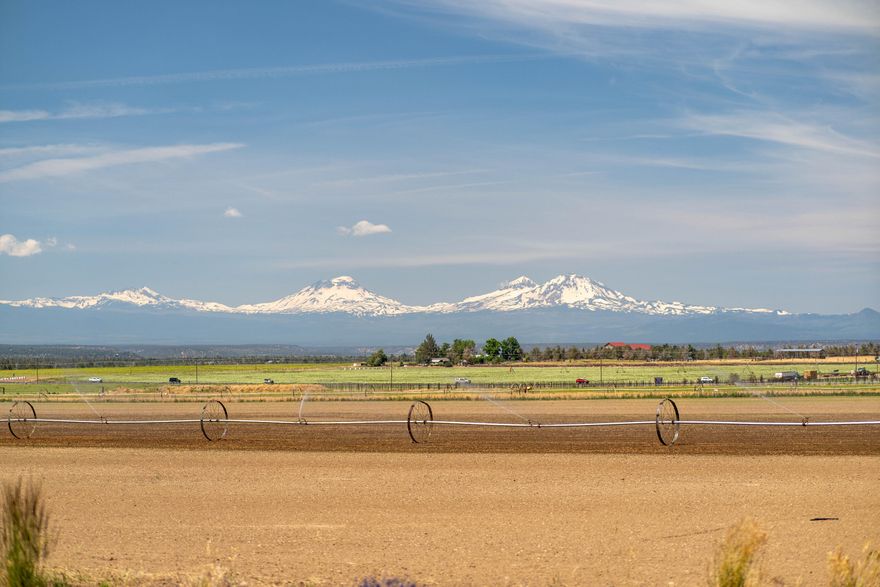 39.1 Farm acres EFU. Redmond Schools. Land currently leased, with option to renew. 35.8 acres of Water Rights. Out buildings include, Insulated Heated shop with concrete floor 40x36, hay barn 48x40, Machine shop/shed 108x40, Store room 10x36, Pump house 8x10, corrals, RV hookup/Dump, a large pond with water feature. A prime location and excellent amenities for cattle or horses. Landscaping  surrounds the beautifully updated Single Level home. Enjoy stunning views of the Cascade Mountains & Smith Rock from this Country home, featuring an open floor plan, dining room, great room, fireplace and walls of windows for views and natural light. A  large kitchen with island, granite tile countertops, propane stove, wall oven, desk, walk-in pantry, and breakfast nook. Main level private primary suite and master bath. 3  bedrooms , potential for 5 beds, with 2 large office spaces, laundry/mud room .Tons of storage and an oversized 3 car garage, with finished floor.
Agent related to Seller.