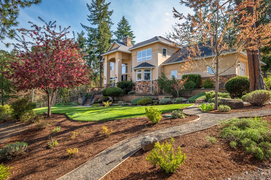 Just a short drive south of Ashland, Oregon, lies this private 22-acre retreat. This private estate features a custom home, a recently built 5,000+ sq ft shop with striking modern design, plus sweeping views of the mountains. Inside, the home welcomes you with a bright entry foyer, cathedral ceilings, and a Tulikivi soapstone stove. The modern kitchen is equipped with high-end appliances and flows seamlessly into the dining room and living area. The main level also includes a spacious guest bedroom, full bath, walk-in pantry, and utility room w/half bath. Upstairs, the primary suite offers a walk-in closet and luxurious private bath, accompanied by two additional bedrooms, a guest bath, and a 2nd laundry room. The shop includes flexible space for vehicles, hobbies, a gym, or workshop. Outdoors, enjoy 900 feet of Slide Creek, hike through the well-maintained forest, or unwind in the hot tub. This is a rare blend of seclusion, usable land, recreation, and convenience.