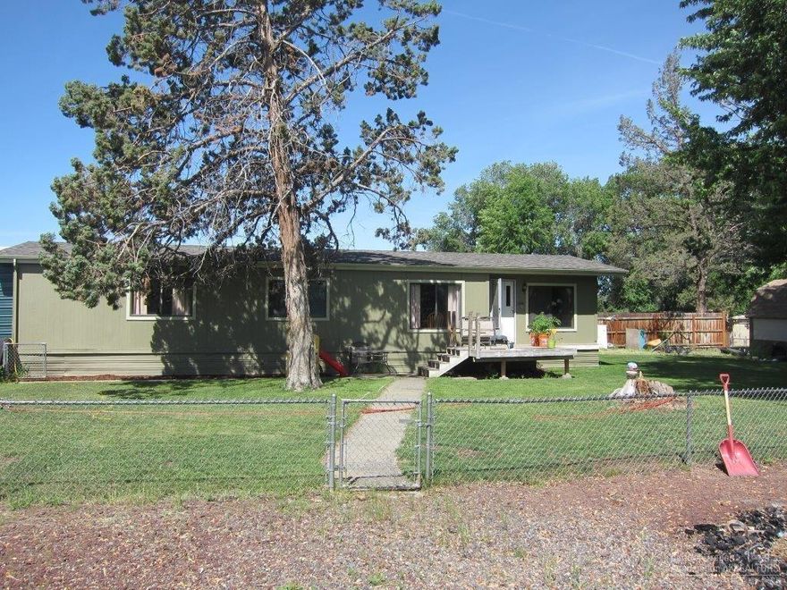 Big corner lot, fenced with lots of parking. The house lives large with a nice living room & dining area. Master bedroom has a walk-in closet & plenty of space. Oversized heat pump will keep you warm in the winter & cool in the summer. 2 wooden sheds on lot plus a 2 car metal carport and a 10x56 metal cover over the back cement patio which provides lots of storage.