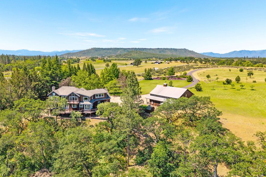 Riverfront Luxury on 31.57 Acres- Southern Oregon living at its finest! Exceptional Rogue Riverfront estate offering breathtaking river views from the home along with low-bank river access and 13.7 acres of irrig rights from the river. Enter through a gated driveway past serene bass pond to a beautifully designed home and quality-built shop. The 4,389 sqft home was crafted to capture the stunning river views. Expansive windows & multiple decks for ideal outdoor living. Inside, enjoy an open floor plan, beautiful kitchen w/ butler pantry, and a luxurious rock steam shower.  3 bdrms, 3 full baths and 1 ½ bath.  Upstairs features 2 spacious bdrms each w/ private decks—one with a sitting area. The lower level includes a full bath and great room, perfect for guests, games, or a caretaker. Addtl bonus room for your needs.  The impressive shop has a full bath, RV hookups, and an upper-level loft. Fenced, cross-fenced, irrigation systems in place. This is a rare gem! Agent related to seller.