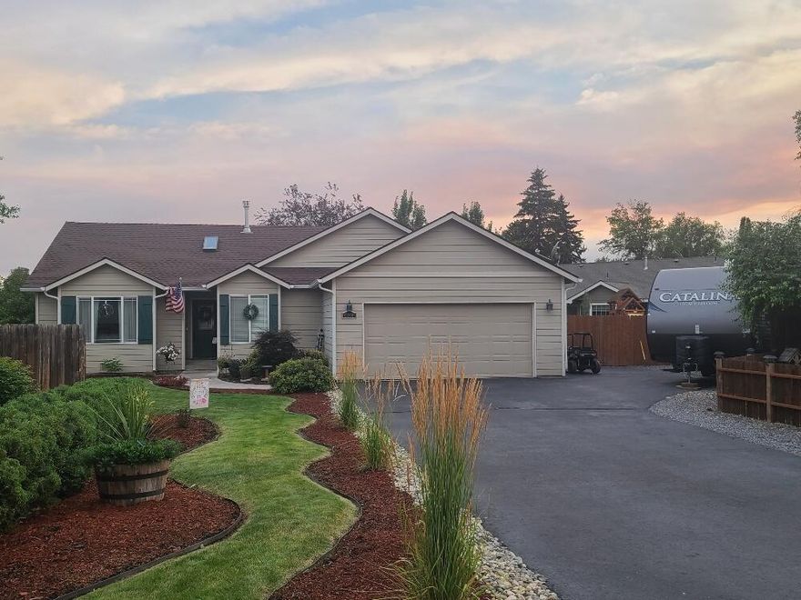 You won't need to lift a finger on this one! Notice all the extras like the super cute barn door on the laundry room, the updated interior doors, new granite counter tops, and the very classy gorgeous colors throughout! Or sit back and enjoy your perfectly manicured landscape while you sit in your new hot tub. Oh... did I mention all of the appliances are included? There is plenty of parking for your cars and for your RV in addition to the 2 car garage. Don't miss the whole gated grassy area on the side of the house for your furry friends, including a doggie door. Look no further... this is the perfect home for you!
