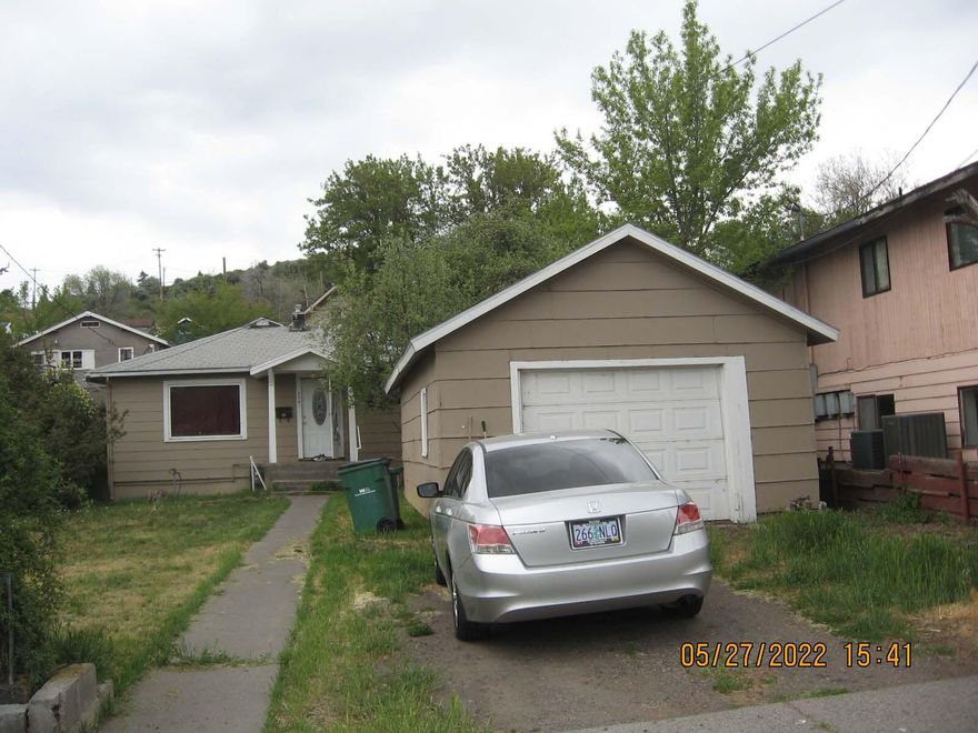 Large rooms with eat-in country kitchen!  Home was renovated in 2018-2019 with new vinyl windows, laminate water-proof flooring, bedroom carpeting, interior and exterior paint, garage roof, gas furnace, new kitchen countertops and sink.  Super large bedrooms and closets with some built-ins.  Large laundry/utility room could also function as a small office or play area.  Oversized 448 Sq.Ft. garage with workbench and newer overhead door.   Home sits back on the lot so the usable yard space is in the front and west side of the home.  Quiet neighborhood with a irrigation canal across the street.  Property is partially fenced.  Currently rented at $1,025/month.  Tenant would like to stay if possible.  Listing agent is one of the owners/sellers.