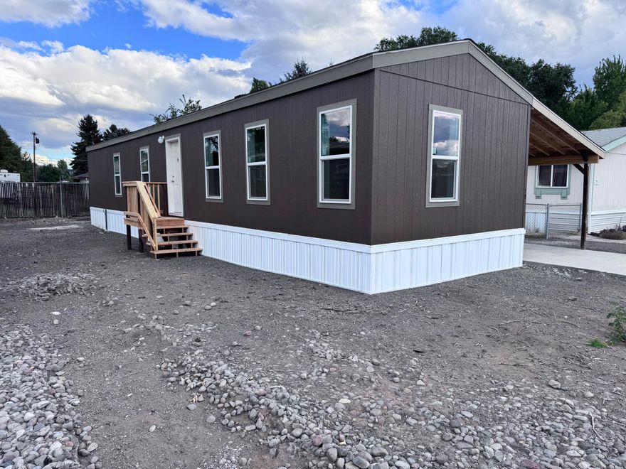 This brand new 3-bedroom, 2-bath manufactured home blends modern design with comfortable living. The open floor plan feels bright and spacious, with durable vinyl flooring throughout and stylish, contemporary finishes.
The primary suite is your private retreat, featuring a walk-in closet and an ensuite bath. The home also includes convenient washer and dryer hookups and a carport to keep your vehicle protected. Everything in the home comes with a warranty, offering peace of mind and worry-free ownership.
Located in the well-maintained Shasta Glen Mobile Home Park, this move-in-ready home is perfect for modern, low-maintenance living!