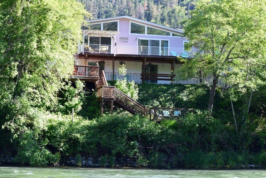 RIVER FRONT! This must see river home has a lot ot offer the new owner such as the view, size of home & property, fishing and can be a multi-family or multi-functional uses. This 5 bed 3.5 bath home has a combined square footage of 3600+ SF. Main level is a 3bed 2.5 bath approx 2033 SF not including the attached garage, shop. Lower level is approx 1980 SF and is used as a successful Airbnb with approx 1200 SF living space with a 2 bed 1 bath & full functioning kitchen, bar and living room. Out of the approximately 1980 SF available on lower level, part of the square footage is an additional 1 car garage and separate ''LARGE'' storage area. Lower garage has its own entry into lower level. Nice decks on both levels with staircase down to the Rogue River. The home sits on .53 acre and across the street is another fenced .10 acre used for septic and a dog run for the Airbnb pet guests. Total property is .63 acre. Buyers to do their own due diligence on condition and use of home/property