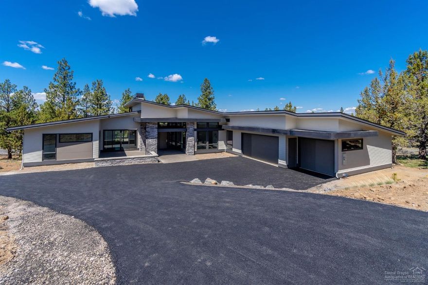 Spectacular NW Contemporary single level on .75 of an acre with some mountain views. Great room plan, dining area, informal island bar seating. Den/office Master bedroom is separated from other 2 bedrooms. Hand textured walls. French oak hardwood. Kitchen w/quartz slab counters, Sapele cabinets, 6-burner gas cooktop. Master bath w/radiant floor heating. A/C, 3-car garage with custom doors, Thermador kitchen appliances, Heat 'n Glo 60'' Messo gas fireplace, Milguard windows. Prewired for speakers. Pre-plumbed for outside firepit. 2-10 warranty included.