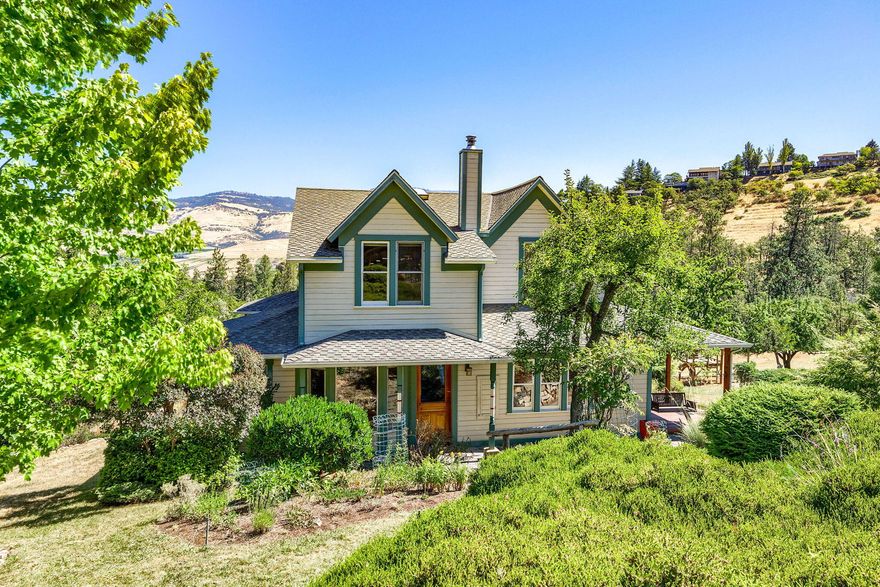 Unobstructed view of the valley & Grizzly Peak can be seen from this beautifully updated 4 bed + den, 2 bath 2500 sq ft, 1910 Arts & Crafts farmhouse. Nestled into a beautiful landscape bordered by seasonal creeks, enjoy the privacy of the country in this slice of paradise, close to downtown Ashland. The home is updated with high quality materials such as Brazilian cherry floors, double hung windows & Restoration Hardware lighting. A Vermont Castings wood stove adds coziness in winter while a new HVAC provides heating & cooling year round. The spacious eat-in kitchen opens onto a screened-in porch, overlooking a large meadow rimmed by mature fruit trees and a sunny fenced-in vegetable garden fed by an abundance of water with a strong well, a year-round spring, holding tanks and a computerized watering system. Across from the home is a charming 1 bed, 1 bath cottage, workshop and barn for storage. This is a must see home & property.