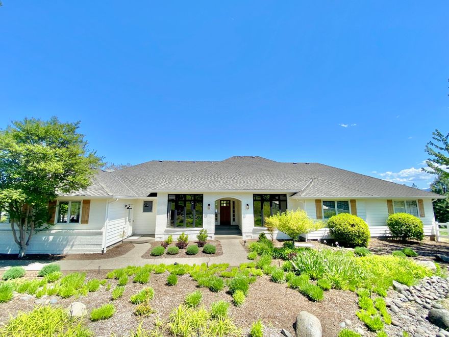 The allure of modern single-level living is beautifully embodied in this custom home that offers panoramic views of the valley and surrounding mountains. Located just outside the historic town of Jacksonville, this residence features four bedrooms and three and a half baths, complemented by exposed beams that add a touch of rustic elegance. The heart of the home is undoubtedly the open kitchen concept, adorned with quartzite countertops and equipped with high-end Wolf and Sub-Zero appliances, perfect for the culinary enthusiast. The home's design also thoughtfully includes an office, exercise room, and formal dining areas that cater to both intimate family dinners and grander gatherings. The three-car garage, a generous utility room, and a pantry enhance the practicality of the home, while the sprawling deck invites homeowners and guests alike to enjoy the picturesque outdoors. For those seeking a blend of modern luxury and serene living, this property promises to be a perfect match.