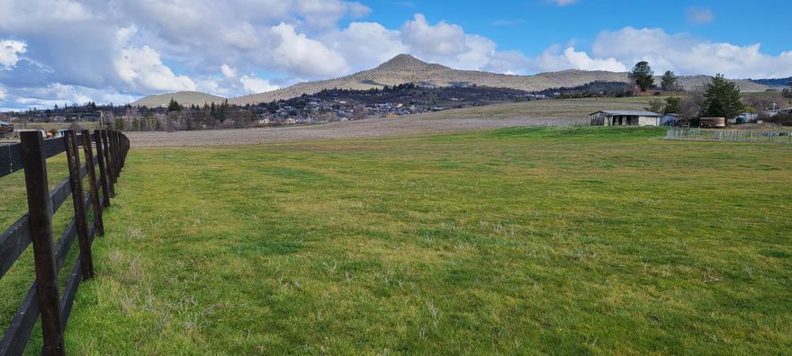 MULTI FAMILY DEVELOPMENT OPPORTUNITY!  6.01 Acres of prime E. Medford high density land with an approved, non-expiring, PUD consisting of 81 units!  5.01 Acres are zoned MFR15 and 1 acre is MFR20.  Buyer may simply submit application, buy the permits and build!  Property sits approximately 1000 feet east of the Albertson's Shopping Center/commercial development with great views of the surrounding valley and mountains.  Existing 2969 square foot home on the property is in disrepair but will hold some development credits.