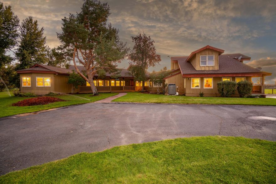 The Swalley Hobby Horse Estate is an exceptionally located horse property with two legal dwellings and a park-like setting. The 18-plus acres is fenced and cross-fenced for horses, with 15.86± acres of water rights delivered by Swalley Irrigation District. The 4,601± sq. ft. custom-built home was remodeled in 2019. Around the primary home, a large lawn opens to the large irrigation pond, surrounded by mature trees, and you will feel like you are in a private park.. This home boasts numerous luxury features and offers breathtaking views of the Cascade Mountains. Additionally, the property features a second 1,026± sq. ft. home remodeled in 2025. Each residence has its own access for privacy and is separated by pasture and lawn. Swalley Hobby Horse Ranch features a 6-stall barn (3 with outdoor runs), additional barn for hay/equipment storage, a beach sand outdoor arena, four fenced pastures, and three loafing sheds. The pastures are watered via automatic underground sprinklers for ease.