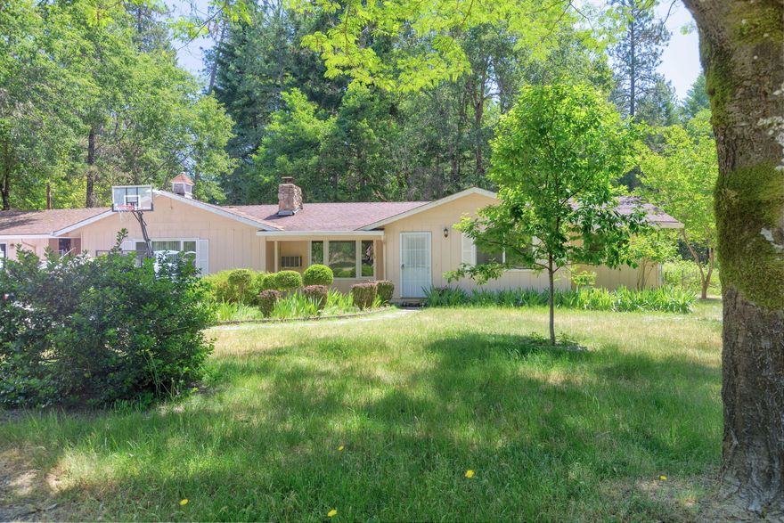 Location, Location, Location! Discover this lovingly cared-for home situated on 2.18 level acres, offering both tranquility and convenience. This property features 3 bedrooms, 3 baths and 2,127 sf of comfortable living space. The living room boasts a wood stove and new wood flooring. Enjoy a spacious family room with a wood stove and abundant storage. New carpet in all bedrooms ensures comfort and style. The kitchen includes a pantry and the dining room features French doors leading to the back deck, perfect for outdoor dining and entertaining. Freshly painted inside and new plumbing underneath the house.  A seasonal creek enhances the natural beauty of the property. Located close to city services and move-in ready, this charming home offers the perfect blend of rural serenity and urban convenience.