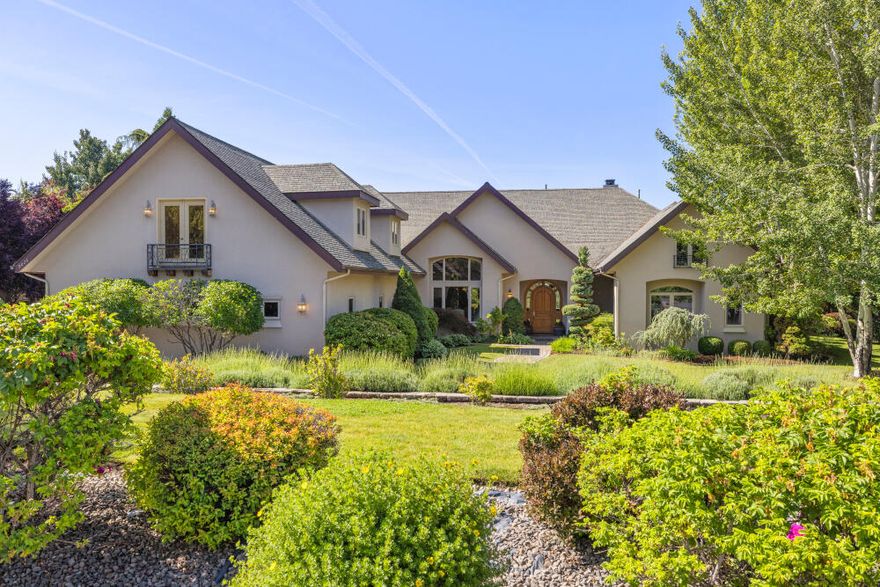 Custom-built French Country estate located on 1.05 acres in the gated Shield Crest Golf Course community. This thoughtfully designed home offers main-level living with 3 bedrooms and 4.5 bathrooms, including two potential primary suites. The open-concept layout features vaulted ceilings with custom wood beams, Oregon oak hardwood floors, and an expansive great room with a gas fireplace. The gourmet kitchen includes granite countertops, custom cabinetry, top-tier appliances, a butler's pantry, wet bar, bar fridge, wine closet, and breakfast nook. A formal dining room provides ample space for entertaining. Main primary suite features a step-in steam shower, oversized soaking tub, dual closets, and private patio access. Upstairs bonus space offers flexibility for a media room, home gym, office, or additional suite. Enjoy outdoor living with a heated inground pool, hot tub, mature landscaping, and a large paver patio. Additional features; oversized 3-car garage and generous parking space.