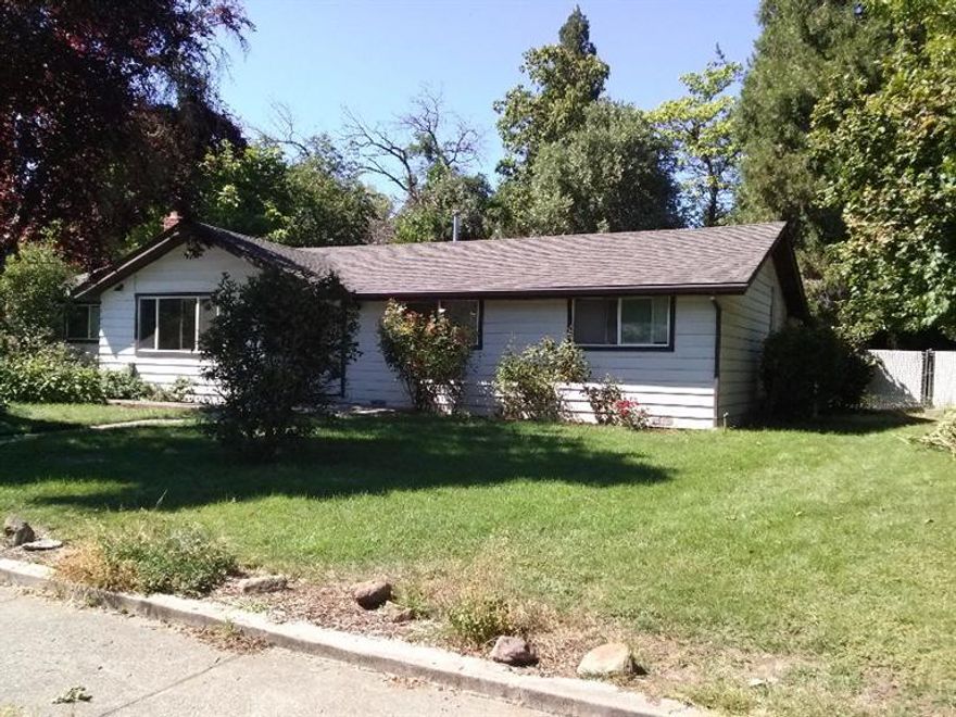 A Charmer 3 bedroom 2 bathroom home is located just one block from the Rogue River. Recent kitchen upgrades include granite tile counter tops. Newer Oak cabinets, custom tile back splash, newer flooring and stainless steel appliances. Fresh paint, vinyl windows and modern lighting are some of the other features you will enjoy as the new homeowner. This home has both a family room and a living room/entertainment room or you can have your office/den. Large over sized backyard. Nice park is just down the street.