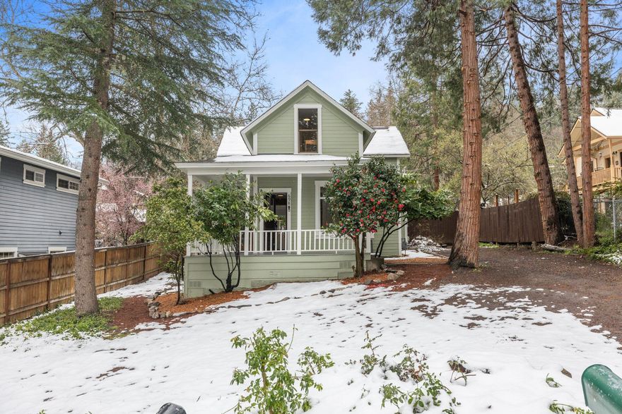 Experience the quintessential charm of Ashland! Nestled in a prime and private location above the Boulevard, just a short distance to downtown, stands one of the original farmhouses in Ashland, now over 100 years old. This solidly built home has original refinished hardwood floors complemented by an airy, newly renovated kitchen boasting new appliances and butcher block countertops. Sheltered under large trees, the house features three original bedrooms, all with hardwood floors and a ductless mini-split system. Enjoy the convenience of a main level bedroom and full bathroom, with two bedrooms and an added bathroom upstairs organized around an original clawfoot tub. Outside, the landscaped lawn adorned with bark, flowers and a plum tree includes a rocked patio bordered by the original stone farm wall. Sitting on a .22 acre lot with irrigation rights, there are endless possibilities. With its blend of timeless allure and modern comfort, this unique Ashland home is truly a gem.