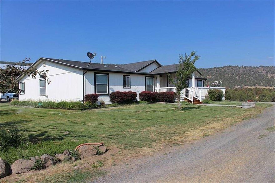 MT SHASTA VIEWS with irrigation well! Private 167 acres, 2 pivots, 5 wheel lines, newer variable speed pump and boles. 108 irrigated acres; excellent soils for alfalfa, grain & pasture, has been in spuds. Balanced for cattle & hay rotations w/pole & livestock barns, corrals, fenced/cross-fenced. Gorgeous 3 bedroom, 2 bath 2706 square foot manufactured home w/high ceilings, acacia hardwood floors, huge kitchen w/island & new granite counters, grand master suite, all new bathrooms from the tile floors to the top-notch fixtures. Heating is heat pump with air conditioning. Views every direction, decking on 3 sides, garage/shop, beautiful landscaping and garden.
