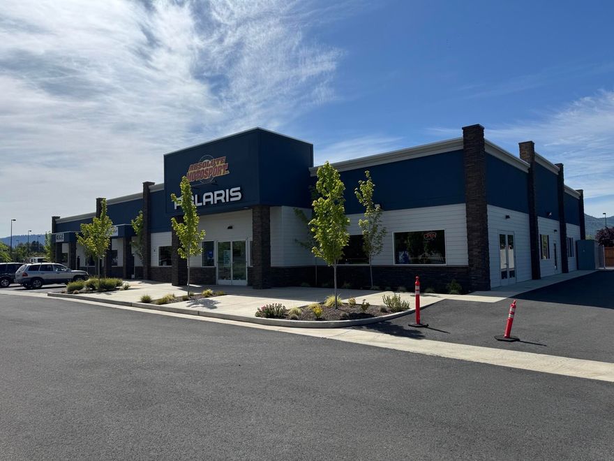 Nearly new commercial building located adjacent to Home Depot in Grants Pass. Extremely nice, well kept building and property that is currently a 3-tenant setup. Approx. 12,000 SF total building size on approx. 1.5 acre property. 9,340 SF is occupied by a motorsports company with a large open showroom, several private offices, a breakroom, and a back shop space. Fully climate controlled throughout. There are two smaller 1,330 SF tenant spaces occupied by a physical therapy business and a hair salon. The two smaller tenants will remain, but the large space is available for an owner-occupant or tenant. High exposure property situated just to the NW of Home Depot as an outparcel to their parking lot. Please do not disturb tenants.