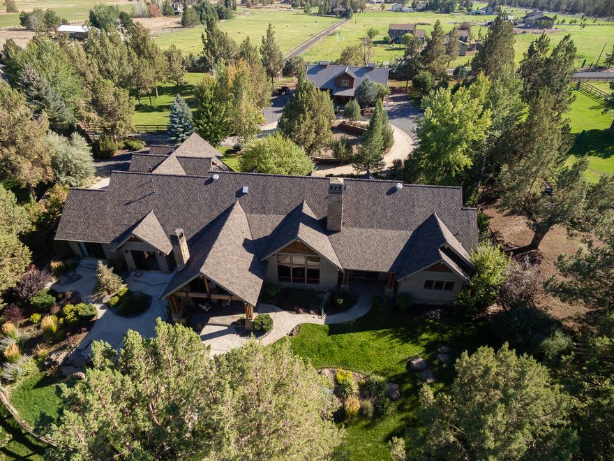 Beautiful gated equestrian estate in Deschutes River Ranch. This incomparable property fits the most discerning buyer. Gorgeous living room features beams
and a rock fireplace with built ins. Chefs kitchen with breakfast nook and formal dining area for entertaining. The home and patio overlook the ranch pastures,
enjoy the outdoor wood burning fireplace while relaxing after a long day. Main level living with master and 2 full guest suites plus office and tv room. 4th
bedroom or bonus upstairs with full bath. Plenty of storage! Attached 3 car garage, detached 3 car plus sprinter/boat bay. 5 Stall barn w/wash rack area (hot
water), medicine room w/laundry hookups & sink, tack room w/sink & small fridge hookup & 1/2 bath all on the main floor. 1 bed 1 bath guest quarters above.
Fully fenced and cross fenced, enclosed garden area and chicken coop. This is a home that must be seen to be appreciated!