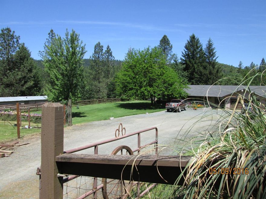 Wonderful horse property. 6.45 fenced/ cross fenced acres comes with barn/shop with private office and 1/2 bath. Attached 3 horse stalls with individual corrals. Spring fed pond, registered exempt reservoir approximately 150' x 50' x 6'. Fenced pastures with seasonal creek. Outstanding garden area with raised beds and established berry bushes. The Ranch style home boasts a large kitchen with custom made island on wheels, a large stone fireplace/mantel with wood burning insert, three bedrooms, 2 bathrooms, laundry room and an attached 2 car garage. Finally, don't forget the RV parking/ concrete pad next to the garage with RV hookups.....Please call to set an appointment to view.