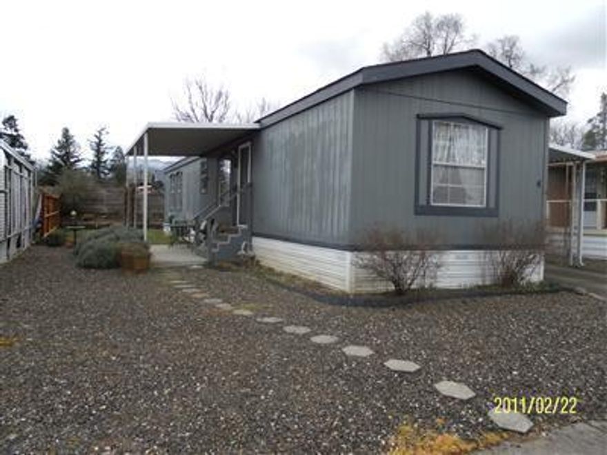 Motivated Seller! 2 bdrm, 2 bath home located in Greenway Village a 55+ community. Split floor plan with vaulted ceilings, ceiling fans, textured walls. Newer cook top, wall oven, counter tops, faucets, sinks and interior paint. Also included new washer & dryer, refrigerator. All furnishings can also stay except TV & TV components. Easy care yard, storage shed, covered carport, new electric lawn mower. Space rent $330/mo includes water, garbage & sewer. Conveniently located between Phoenix & Talent.