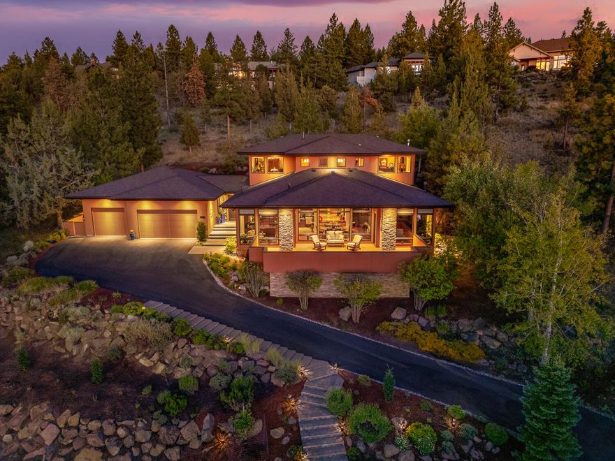 Spectacular in every way, this custom contemporary Prairie-style home offers 4,077 SF of luxurious living space with an open floor plan for entertaining. Situated atop Awbrey Butte on a private 0.67-acre lot, enjoy sweeping views of Cascade Mountain peaks and tranquility. Upgrades include a new 50-year presidential roof, custom wet bar with kegerator and wine fridge, whole house carbon filter, water softener, humidifier and smart home features. Grand foyer with hardwood flooring, two stunning primary suites upstairs and a third bedroom on the main level. Soaring ceilings integrate living, dining and kitchen areas. Gourmet kitchen with granite countertops flows into a cozy breakfast nook and dining area. Inviting living room with fireplace and expansive windows. Impeccable rock work and water feature outside. Spacious deck and patios for outdoor gatherings. Three-car garage with custom cabinetry and workshop. Epitome of refined living, modern convenience and exquisite craftsmanship.