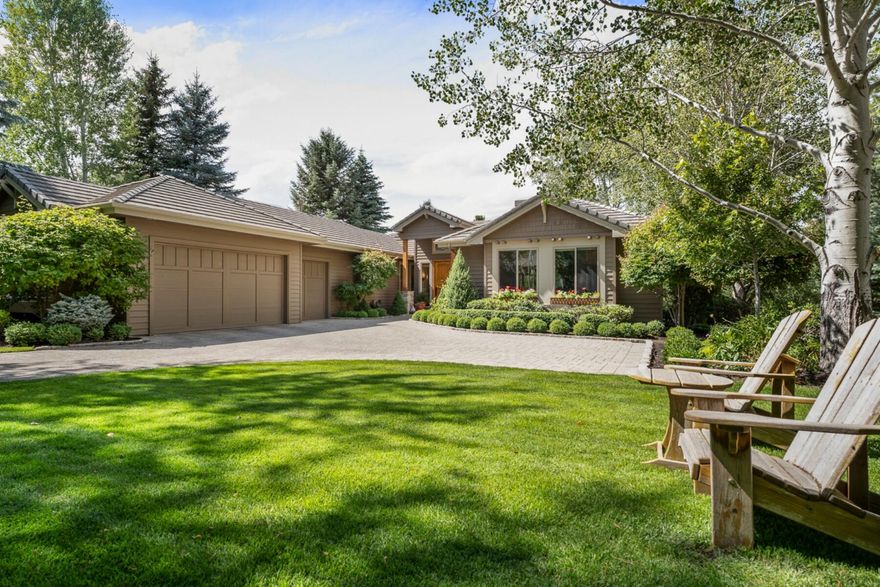 This single-level home is located in Broken Top & is enveloped by meticulously maintained English garden landscaping, w/ outdoor water feature, deck with hand-crafted wrought iron railings, & beautiful paver driveway. Backing to a vast green space, the sense of privacy and openness is enhanced. Inside, the home boasts vaulted ceilings. Sunlight pours into the home through large windows. The living room has new lighting in bookcase & ceiling & marble tile surrounding the gas fireplace. The large, open kitchen is adorned with new Quartzite natural stone countertops, Pratt & Larson handmade, embossed tile backsplash, new Jennair refrig & stove, solid wood cabinets and an abundance of pantry space, ideal for culinary enthusiasts.  The primary bedroom, has a spa-like bathtub & a beautifully tiled walk-in shower. The home has guest en-suite, perfect for visitors. Addt'l features include a highly efficient hot water recirculating loop, plus a roomy three-car garage.