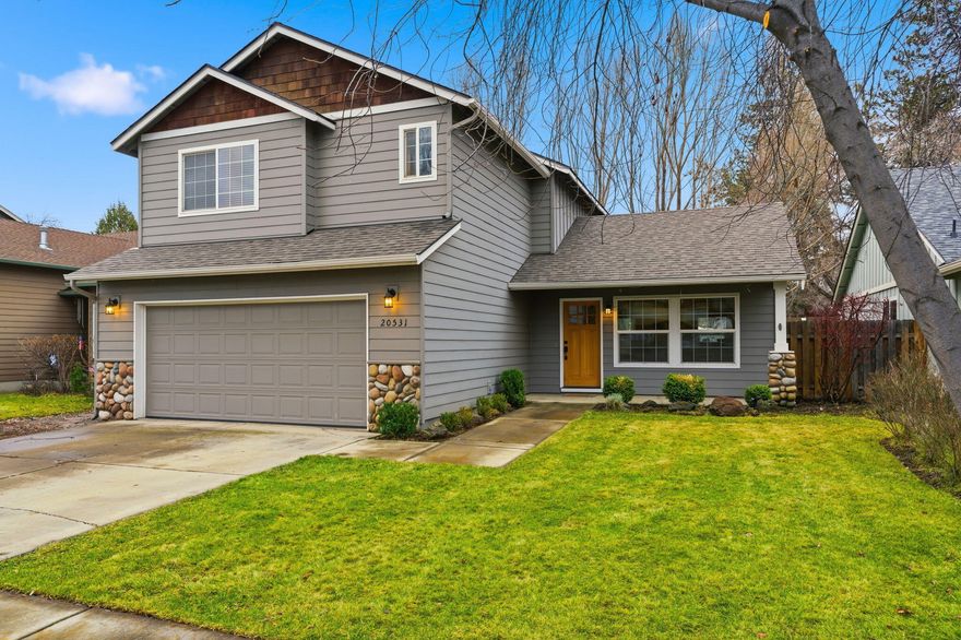 Located in a desirable SE Bend neighborhood near Stone Creek Park, this home is just minutes from the Old Mill District and Deschutes River access. Thoughtfully updated, it offers modern elegance and functional living. The main level features LVP flooring, an upgraded kitchen, gas fireplace, and an open floor plan ideal for entertaining. All bathrooms have been beautifully remodeled, including a solid quartz countertop in the primary bath. Sliding glass doors open to a privately fenced backyard with mature trees and garden boxes ready for planting. Relax on the patio beneath the new pergola or host summer gatherings in the spacious yard. New roof in 2024.