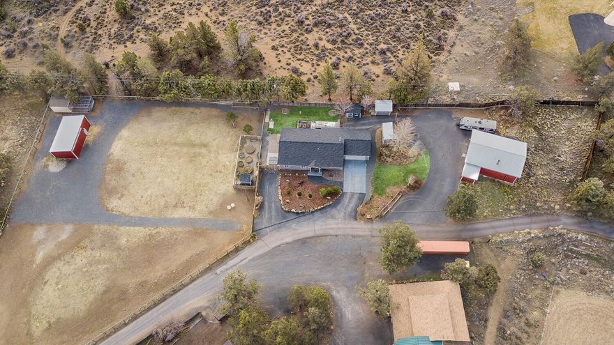 Incredibly cute property with pasture views and country vibes on 1.5 acres (1 acre of COID), and only 4 miles to Bend's Eastside. Built in 2018, this low-maintenance single-level ranch style home features a bright open floorplan, concrete countertops, breakfast bar, wood burning stove, and freshly painted kitchen cabinets. The exterior is a hobby farmer's dream with chicken coop, fenced garden area with raised beds, and large grass field for the animals.  The back patio boasts an outdoor firepit, horseshoe pit, and private hot tub area.  The property includes a 720 sqft heated hobby barn for all your yard equipment and toys with 220V. There are several other outbuildings: Tuff Shed ''man cave'' with power, irrigation pump house, wood shed, and small livestock stable near the field. This property is a must see!