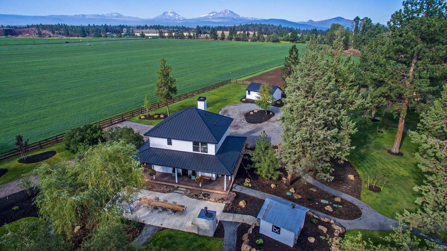 About as close to downtown Sisters as you can get and be on a true farm. Home is a completely remodeled classic farmhouse and has an additional guest house (approximately 500 square feet). Expansive views of the Cascade Mountains across green pastures irrigated by 40 acres of valuable 1895 water rights delivered by Three Sisters Irrigation's pressurized system. Interior features: tile walk in showers; antiqued granite slab countertops; hardwood flooring and custom tile throughout. Exterior features: Covered wrap around porch; Extensive park like landscaping with outdoor patios, sitting areas, built-in pizza oven, lighted walking paths; 1.5 acre pond with meandering irrigation ditch. Replacement dwelling permit issued for previous manufactured home.