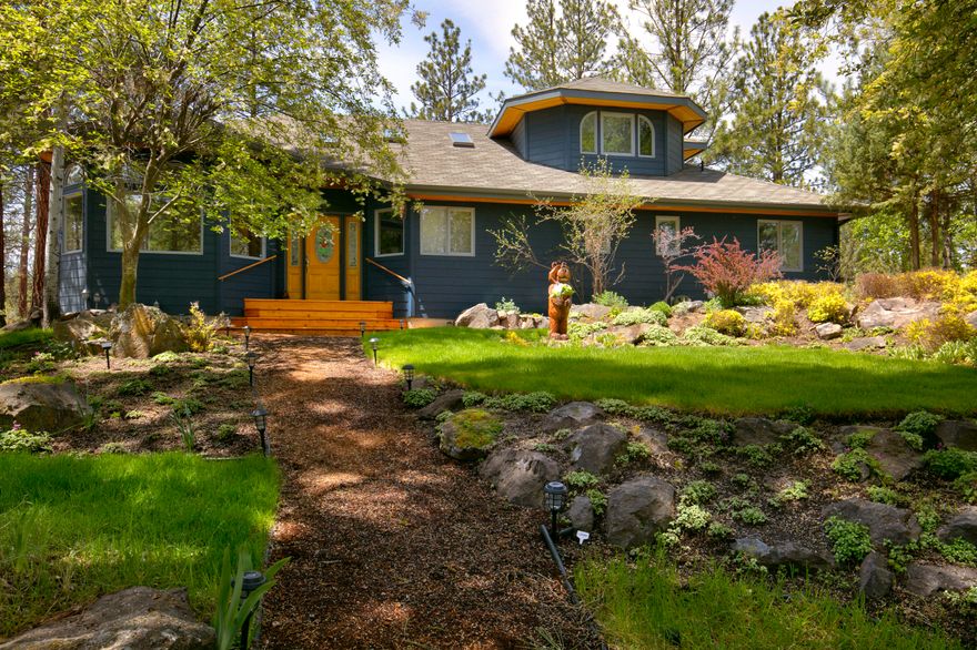 The lifestyle of Bend is wrapped up in this home beautifully situated on secluded 9.34 acres. Only 1 mile away from Shelvin Park and 10 minutes to downtown and Bend's activities. A paved driveway winds to the home's attractive landscape adding serenity to this well-cared for home. Upon entering, natural lighting is captured through the windows that overlook picturesque views of treetops, the ridgeline and canyon within the property. High-end fixtures and finishes are featured in the updated kitchen and primary jaw-dropping bath. Enjoy in-floor radiant heating throughout the home.  2 additional bedrooms are situated on the main level along with a utility room with ample storage.  The oversized 2 car garage has a workbench and excess storage - perfect for tuning bikes or waxing skis.  Year-round entertaining possibilities are endless. Enjoy lunch al fresco and soak up the sun on the spacious deck. This fantastic property is uniquely secluded yet adjacent to the Saddleback neighborhood.