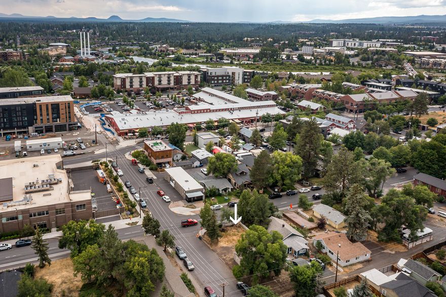 This 0.10-acre corner lot offers a rare infill opportunity in Bend's Old Town Historic District, ideally located across from Market of Choice and a block from the Box Factory. Enjoy exceptional walkability - 10 minutes in either direction to downtown or the Old Mill - with a Walk Score of 84 and Bike Score of 87. Zoned RM (Residential Medium Density), the lot supports multiple middle housing types under Bend's updated code, including duplexes, triplexes, townhomes, and cottage clusters. A Middle Housing Land Division (MHLD) could allow up to three lots with separate utilities, subject to City approval. The City has indicated a duplex or triplex is feasible, but new construction must meet Historic District design standards and undergo Landmarks Committee review (Type III). Right-of-way and utility upgrades - including new sidewalks - are required. No direct access from NW Colorado or NW Lava; alley access only. Buyers should verify all requirements with the City of Bend.