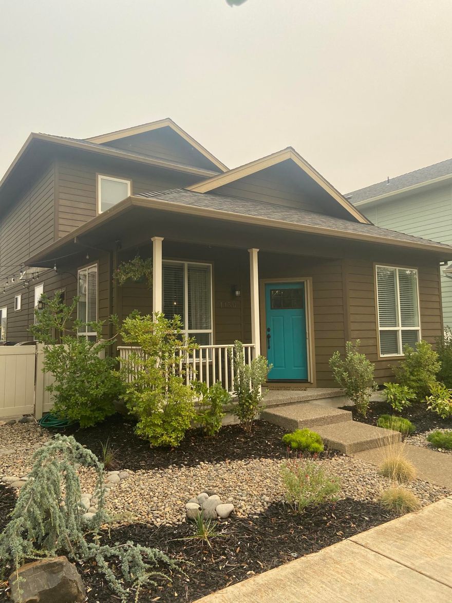 You must tour this home to appreciate it.  This home boasts an open floorplan and shows very well.  The home features vaulted ceilings, custom cabinetry, hardwood floors and granite counters.  The floorplan has a large downstairs master suite and 2 guest bedrooms upstairs with a large area that could be used as an office, workout room, craft room or playroom.  There are numerous parks, open spaces and play areas through out the development.  There is a large grassy park just across the street.  This home is very low maintenance and has a wonderful front porch.  You will not be disappointed.