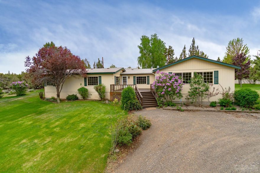 Must see property on south edge of Eagle Crest. Enjoy an extremely private & serene setting w/a sprawling lawn & ready to go garden. 2628 sf home w/stick built addition offers space to entertain year round, extending to the covered deck & front sun deck. Kitchen w/plenty of counter space, additional Buffet & formal dining. Master Ste w/soaking tub & walk in shower. Multiple living spaces to accommodate a lg family or gathering. Over sized, extra deep dbl garage w/built ins & Office/bonus area & a cold storage room. Shop has full sized doors for RV storage, 220 power & slab floor. Complete RV hookups w/turnaround, additional single garage & additional storage buildings! Property is gated & fully fenced. Terrain views clear to Smith Rock!