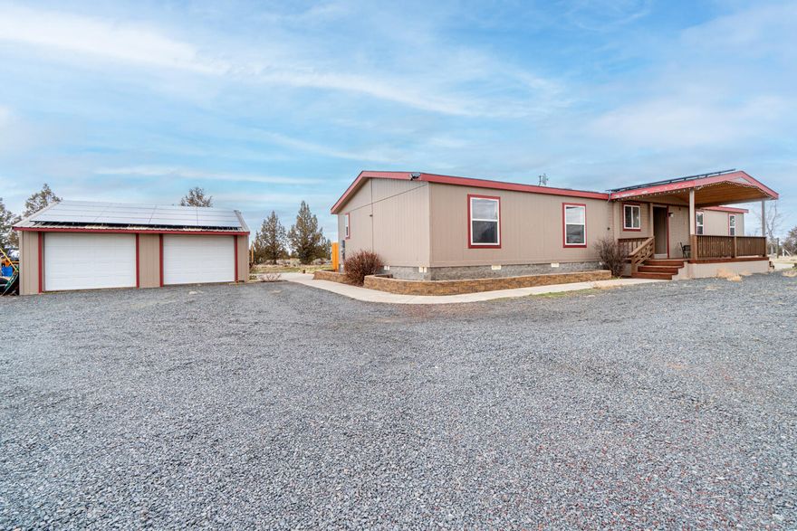 Dreaming of your own piece of Central Oregon where you can step out your back door to miles of BLM land - this is it! Situated on just over an acre, this home has a gated entry, solar, partial wrap around porch, & more! Covered entry leads inside to an open floorplan filled w natural light, tons of windows, carpeted living space & neutral paint schemes. Kitchen ftrs breakfast bar seating, skylight, plenty of counter/cabinet space. Well sized bedrooms & baths w/shower/tub combos. Additional living space offers its own private entry/keyed door, second water heater, small kitchenette w/sink, spot for a mini-fridge too! Covered front deck is great for morning coffee & back deck wraps around to one side & offers private entertaining & bbq area w/an additional covered portion off the double doors to kitchen. Direct access to BLM out the north property line. Electric forced air heat w/heat pump & air conditioning too! Detached double car garage & chicken coop as well! Solar Is owned & stays!