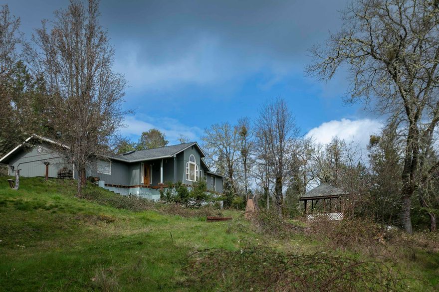 Great Property Near the Applegate River on over Seven acres , backed by BLM Land. 
This 1994 home with over 2000 square feet , needs some updates, but is in the Perfect spot with the best views! Currently we are building a BRAND new DECK around front facing side of home. It will be gorgeous (see attachment- home price includes new deck.) Stunning views from this single story home. Huge kitchen with vaulted ceilings, island, pantry and skylights. This place has plenty of natural light . Extra workshop outside too , with electric. Plenty of space to build another shop as well. Towards bottom of property there is also another cabin like structure , it needs work-but could be turned into something neat. Not a drive by- must bring your broker please. We will be having an Open House on March 23rd 12-4 pm ...that anyone is welcome to attend then !