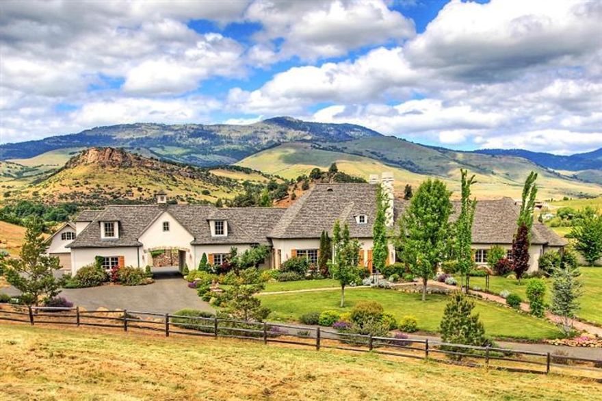 This astonishing French Country Estate lies on the dynamic rolling hills with panoramic views. Located minuets from town of Ashland Oregon, the home of Oregon Shakespeare Festival, also The Top 10 Most Desirable Small Town To Live in US''. The south-facing hillside is ideal for a boutique vineyard or horseback riding. As you entering, a custom designed patina finished gate welcomes to a paved driveway. The 5804 SF with 5 Beds and 5 2/1 Baths home features; Chef's Dream Kitchen, Luxurious Master suite, Library & Theater and attached but separated 690 SF Guest Quarters. Plaster walls with stone accent, pine and stone floors. Beautiful French Country details with brick accent through out. A Charming brick patio with climbing rose trellis opens to a lagoon style salt-water swimming pool with a beach entry. Enjoy entertainment or just sit back with view of iconic Pompadour Bluff. Seasonal creek & pond.