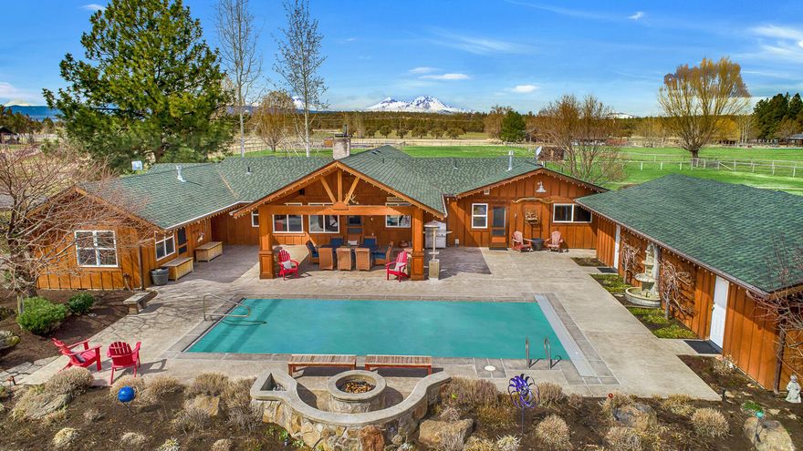 Ranch home nestled in idyllic 10 acre. Landscaping surrounds house for tranquil enjoyment of panoramic pastoral & mtn views. Expansive overhangs on both sides of the house. Back patio is ideal for entertainment around the pool & fire pit. Detached 4 car garage and pool house in addition to 4b/3ba home. Montana Moss stone-wrapped gas FP is central to the vaulted dining & LR with floor to ceiling windows. Kitchen w/ granite counters, induction cooktop, SS appliances, island. Bonus room/home office serves as flexspace. Spacious primary suite w/ heated tile floors, walk-in shower, and walk-in closet w/ custom organizers in cherry wood finishes. Additional Junior Suite & 2bds are on opposite end of living areas, complete with a spacious laundry room & pantry. Long driveway circles the house to the 5600 sqft shop w/ 220amp for hobbies. Hay field w/ pivot and cross-fenced fields w/ in ground sprinklers. Hay barn w/ tack room abuts the corral. 14ft garage doors w/ pull-thru bays for RV storage