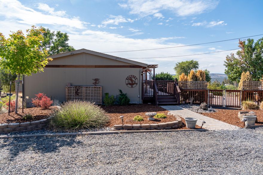 Energy Star Skyline built in 2007 3 bedrooms 2 full bathrooms manufactured home on a foundation, complemented by a 576 sq. ft.detached insulated steel Garage/Shop Highlights include a fenced yard with apple trees, lavender field, and a professional horseshoe pit. The outdoor oasis continues with an above-ground pool, gazebo-covered deck, Hot Springs spa, and auto fountain. Inside, enjoy Corian counters, a granite sink, laminate flooring, and solid-core knotty pine wood doors. The gas fireplace boasts a Juniper surround, mantle, and bench. Discover more in Crooked River Ranch: golf, pool, basketball, tennis, dining, hiking, and more. Call your Realtor Today!