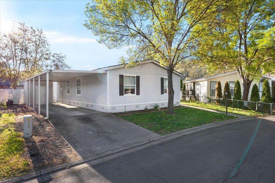 Jump On this opportunity!  Back On Market at no  fault of  home!!  Own one of the nicest lay-outs and largest homes in desirable Butte Crest Mobile Home Park! Enjoy peace of mind with a new roof that was installed in 2022  and a new heat pump installed in 2019.
There is also brand new carpeting!  The spacious kitchen features abundant cabinetry, subway tile, and striking epoxy resin counter-tops. The primary suite offers a refinished shower and updated resin vanity. A large office could easily serve as a 4th bedroom. Custom high-end fabric blinds throughout add a stylish touch. Outside, enjoy a beautifully landscaped yard with custom built raised garden beds, a freshly stained deck, and a unique in-ground  kiddie or doggie splash pool. Move-in ready and full of charm!  Plus all appliances are included!