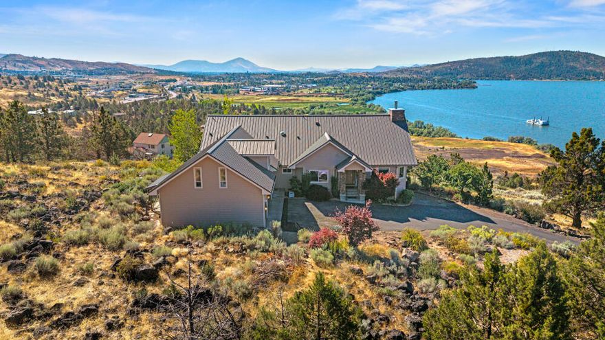 Beautiful open-concept home on sought-after Sunset Ridge with expansive, panoramic views of Upper Klamath Lake and unforgettable sunsets. Situated on a private 5-acre parcel with natural, low-maintenance landscaping, this home combines privacy and convenience—just minutes to town and the medical center. Inside, enjoy an open-concept great room with vaulted ceilings and a gorgeous wood-burning fireplace. The kitchen features granite tile counters, tile flooring, breakfast bar, and a large walk-in pantry. Primary suite on the main level, with two additional bedrooms (one used as an office) plus a spacious bonus room above the 3-car garage. Step out to a covered deck and soak in the views. Lots of storage and just incredible views from almost any room!