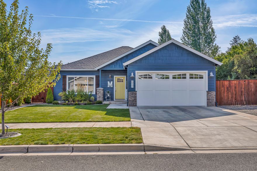 Modern comfort meets effortless living in this beautifully designed home, offering low-maintenance convenience with plenty of space for all your toys. The contemporary floor plan seamlessly blends style and function, featuring a light and bright kitchen with a built-in coffee bar/buffet, large island, stainless steel appliances, granite counters, and a custom tile backsplash. The primary suite is a true retreat with two walk-in closets, a spa-inspired tile shower, and garden doors that open to the patio. Thoughtful upgrades are found throughout, including a cozy gas fireplace, enhanced filtration system, and energy-efficient 8.1 kW solar panels. Outdoor living is made easy with a hot tub, raised garden beds, storage shed, and gated RV parking complete with a 120-volt hookup. Tucked at the end of a quiet street in a peaceful neighborhood yet close to shopping, dining, and amenities, this home offers the perfect balance of privacy and convenience.