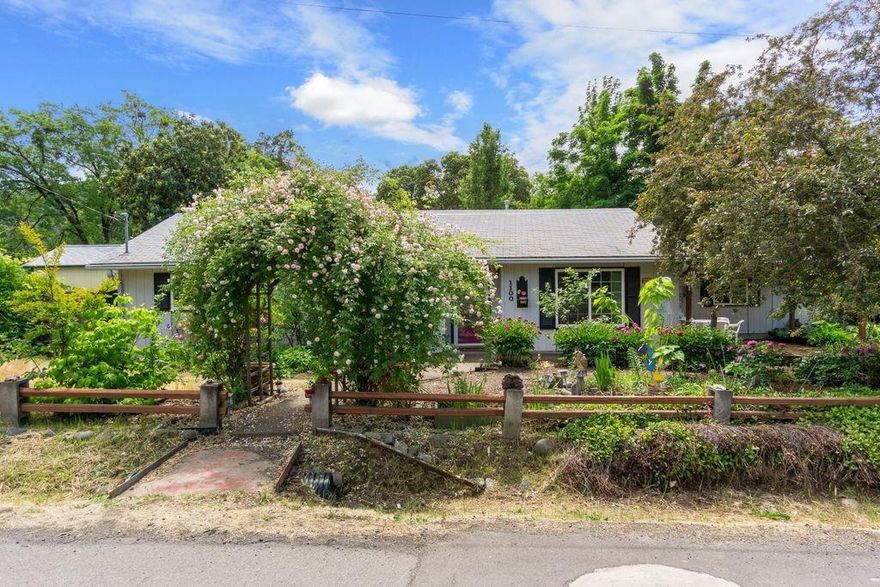 Great Gold Hill location! Mature lush landscaping for outdoor entertaining with rock waterfall, pergola, flagstone patio w/ rock pathways, fruit trees, and large 12X16 Studio that has heating and cooling + tool shed. Tastefully updated home with Bamboo, laminate & carpet flooring, vinyl windows, & kitchen cabinets. Lg garden window in the dining room, kitchen w/ glass cook top, marble back splash & lots shelves for storage & canning. Fenced yard with Railroad Tracks behind the fence. 1 car garage & carport. Room for small RV parking