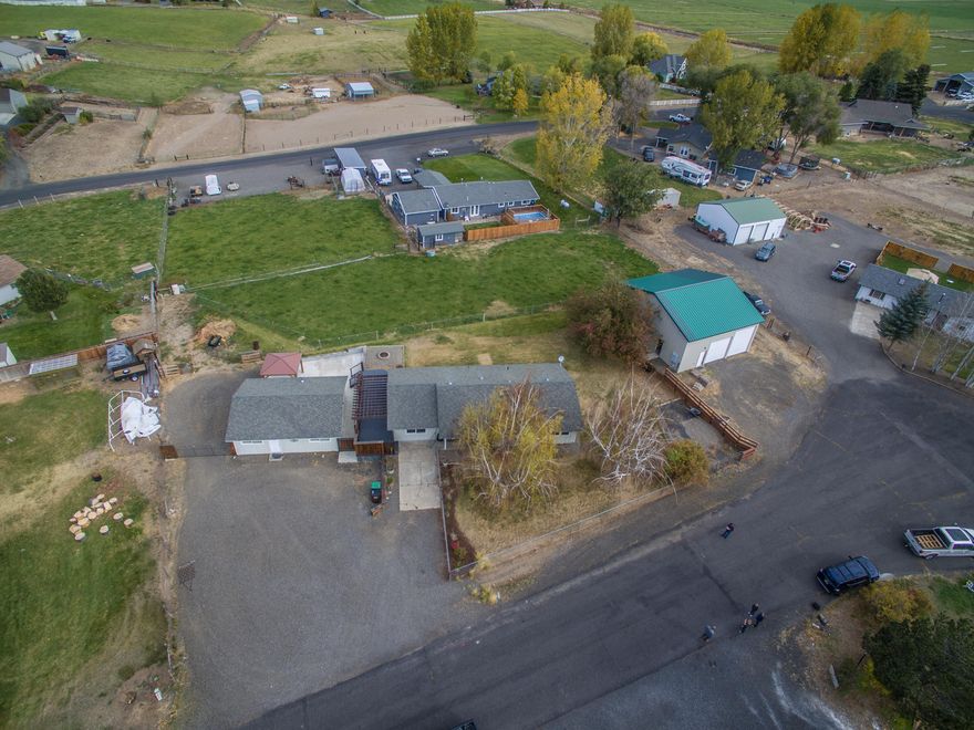 Just like New!  Don't let the date-built sway you from looking at this sweet home on .82 irrigated acres.  Completely updated 1361 square foot 3-bedroom, 1-bathroom with utility room and family room and living room with pellet stove, interior includes new carpet, cabinetry, counters, luxury vinyl plank flooring, appliances, windows, doors, shower/tub combo,  and ceramic heaters.  Fenced and gated irrigated property with separately fenced pasture for livestock.  Detached large shop with 2 roll up doors and ample storage plus a detached studio that is completely finished with propane heat and electricity, lots of storage, luxury vinyl plank flooring.  The property features trex decking, concrete patio with Gazebo, custom firepit and a pergola.  This is a treasure waiting to be found!