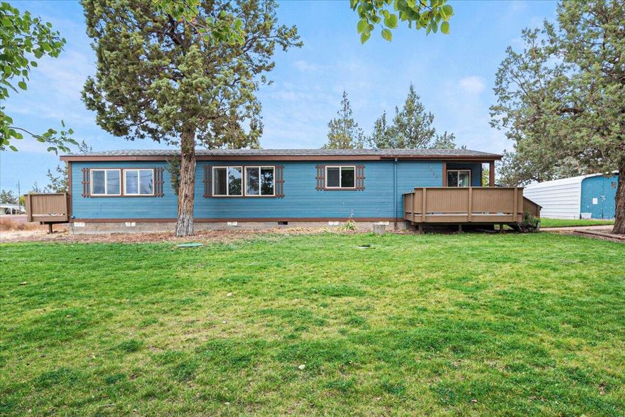 Craving the quiet of country living without giving up convenience? Welcome home to this beautifully maintained 2-bed, 2-bath gem in the heart of Terrebonne. Step into a spacious great room with gleaming tile floors, a cozy wood stove, and oversized windows that flood the space with natural light. The bright and cheery kitchen features granite countertops, a stone backsplash, and sleek black appliances—plus a dining area with a built-in china cabinet. The oversized primary suite feels like a retreat with its private deck access, jetted tub, separate shower, and generous storage. A large laundry/mudroom adds everyday ease with even more storage and direct access to the backyard & back deck. Set on a fully fenced, .32-acre lot, this home has room to play, plant, and park—with underground sprinklers, RV hookups, and a brand-new septic system (2023) Cascade Views too!!