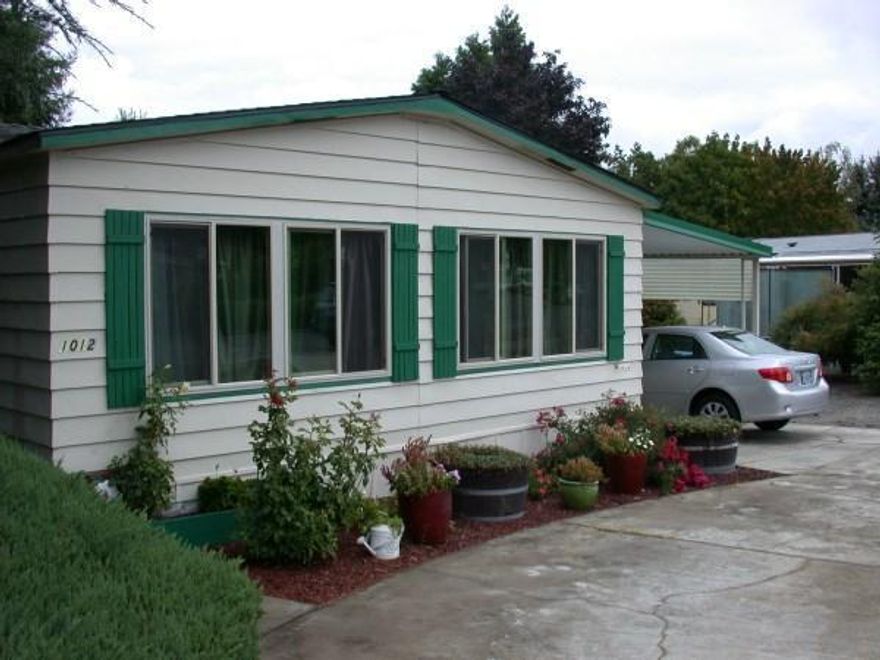 Great updated 1980 Guerdon Manufactured home located in a 55+ Subdivision Park on a large .21 lot with RV Parking and Hook Ups. Home features 2 bedrooms, 2 bathrooms, approx. 1152 sqft, open floor plan. New laminate/wood floors, new roof and energy efficient heat pump in 2012, some new energy efficient windows in 2013 and Oregon Energy Trust weatherize the home. Covered deck, patio, and carport, also includes 4 outbuildings comprised of 1 Work Shop with 220 power, 1 Shed with AC, Storage Shed & Garden Shed.