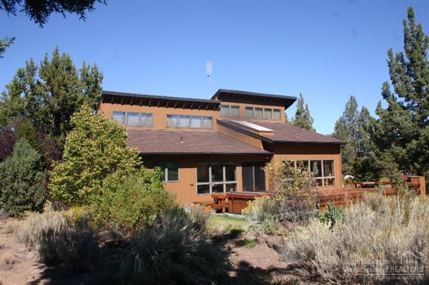 Passive solar contemporary home nestled in the trees with end of the road privacy on almost 20 acres with irrigated pastures. Enjoy energy efficiency (Super Good Cents Home) in this secluded rural setting. Upgraded kitchen, SS appliances, granite slab tops, private office, loft, workshop w/ sink, huge deck w/ hot tub & private well. Room for critters, adjoins open City land & low property taxes (farm deferral). Decommissioned mobile home (12x63) w/ bath for guest quarters, office but not a dwelling.